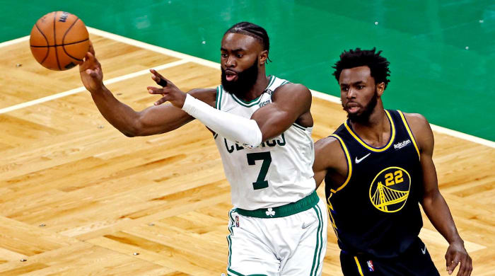 Jun 8, 2022; Boston, Massachusetts, USA; Boston Celtics guard Jaylen Brown (7) passes the ball against Golden State Warriors forward Andrew Wiggins (22) in game three of the 2022 NBA Finals at TD Garden.